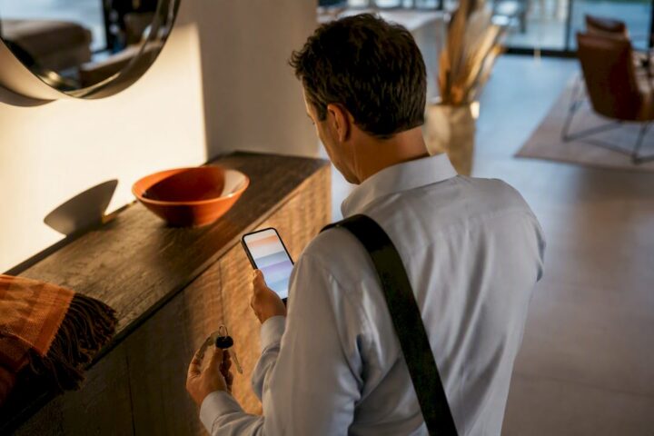Traveler reviewing rental rules at entryway