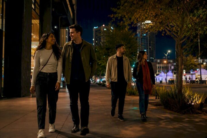 Pedestrians walking downtown Phoenix at night